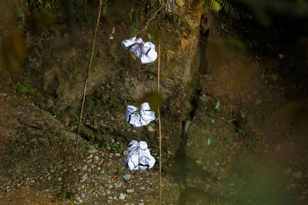 A rescue team recovers the bodies of victims from the site of the plane crash of a Yeti Airlines-operated aircraft, in Pokhara, Nepal January 16, 2023. — Reuters pic