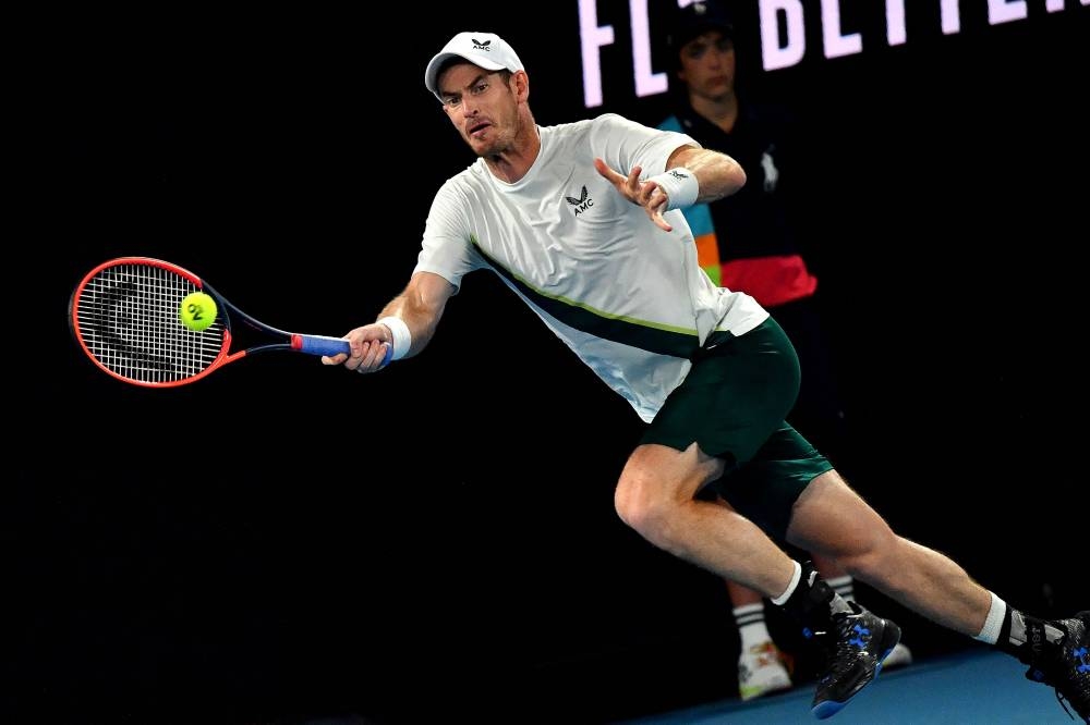 Britain's Andy Murray hits a return against Italy's Matteo Berrettini during their men's singles match on day two of the Australian Open tennis tournament in Melbourne on January 17, 2023. — AFP pic