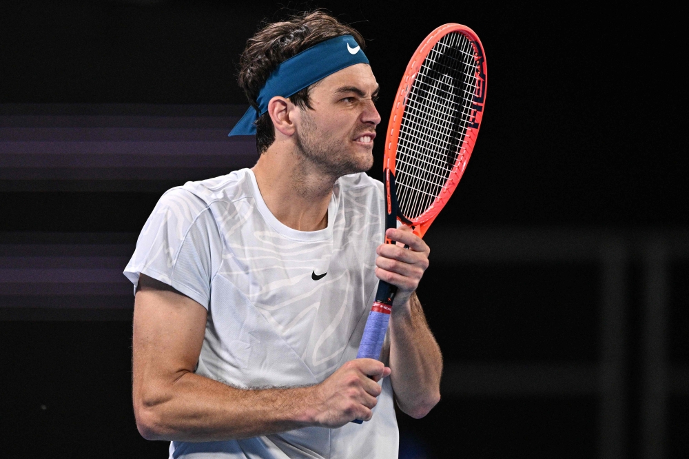 USA's Taylor Fritz reacts after a point against Georgia's Nikoloz Basilashvili during their men's singles match on day two of the Australian Open tennis tournament in Melbourne on January 17, 2023. — AFP pic
