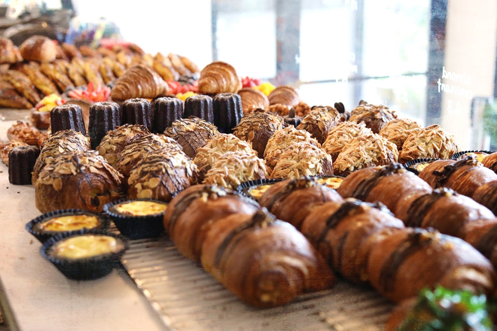 Noon Viennoiserie’s eye-catching display showcases rows of delectable pastries.