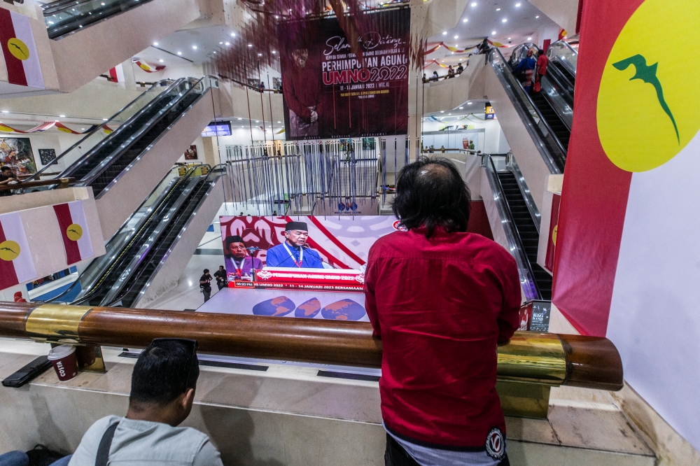 Umno delegates watch a speech by party president Datuk Seri Ahmad Zahid Hamidi streamed live at World Trade Centre Kuala Lumpur January 14, 2023. — Picture by Hari Anggara
