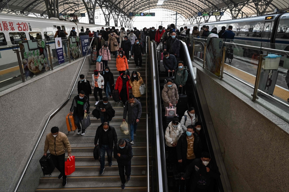 Passengers arrive to Hankou railway station, in Wuhan, in Hubei province, on January 20 2023, as annual migration begins with people heading back to their hometowns for Lunar New Year celebrations. ― AFP pic