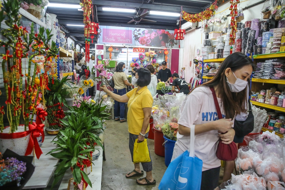 People shop for flowers at Floralife on Petaling Street in Kuala Lumpur January 21, 2023. ― Picture by Yusof Mat Isa