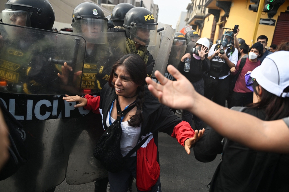 People protest outside the Police Investigation Operations Centre to demand the liberation of the arrested at the campus of the University of San Marcos in Lima January 21, 2023. — AFP pic