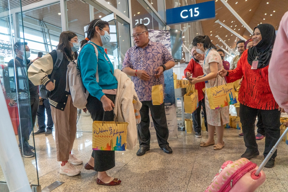 Tourism Minister Datuk Seri Tiong King Sing was at KLIA greeting tourists on fights arriving from China. — Picture by Shafwan Zaidon