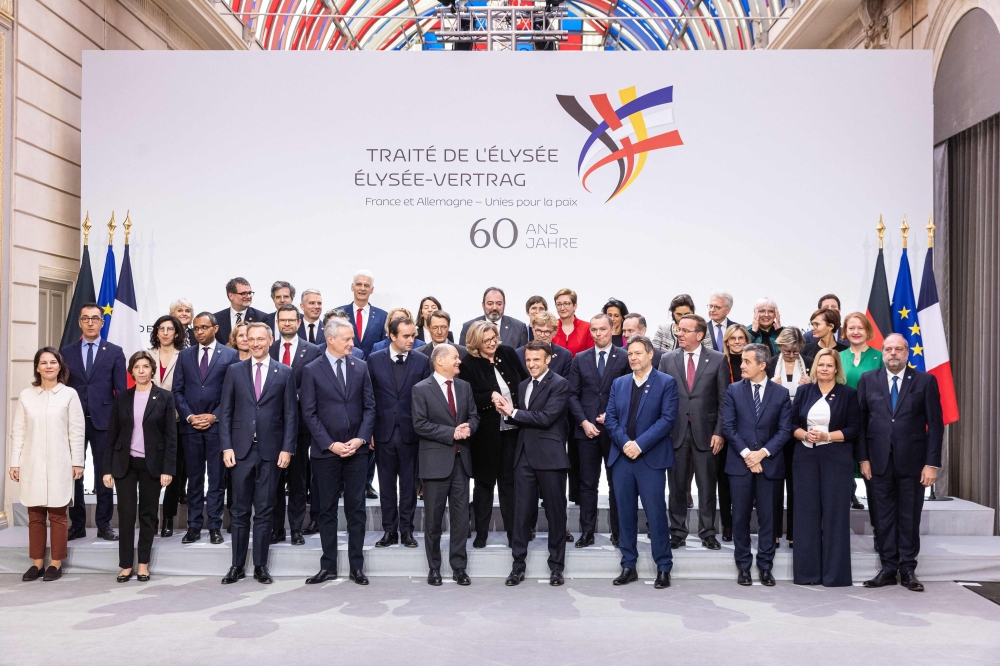French President Emmanuel Macron (Centre-Right), Chancellor of Germany Olaf Scholz (Centre-Left) pose for a group picture with the members of their respective cabinets, prior to a cabinet meeting, as part of the celebration of the 60th anniversary of the signing of the Elysee Treaty, to seal reconciliation between France and West Germany, 18 years after the Second World War at the presidential Elysee Palace in Paris on January 22, 2023. ― AFP pic