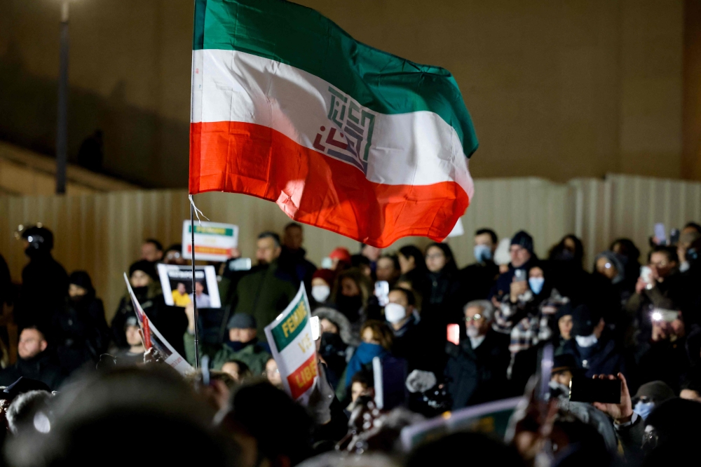 File photo of a protester holding an Iran-themed flag bearing an event slogan on the Trocadero Esplanade Trocadero Esplanade during a gathering to display the slogan ‘Woman. Life. Freedom.’ on the Eiffel Tower, in a show of support to the Iranian people, in the wake of the death of young Iranian woman Masha Amini who died in the country’s morality police custody, in Paris, on January 16, 2023. ― AFP pic