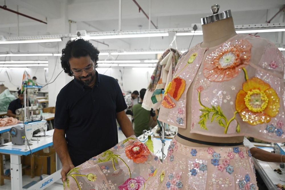 In this photograph taken on October 19, 2022, Indian fashion designer Rahul Mishra checks a design at his workshop in Noida. — AFP pic