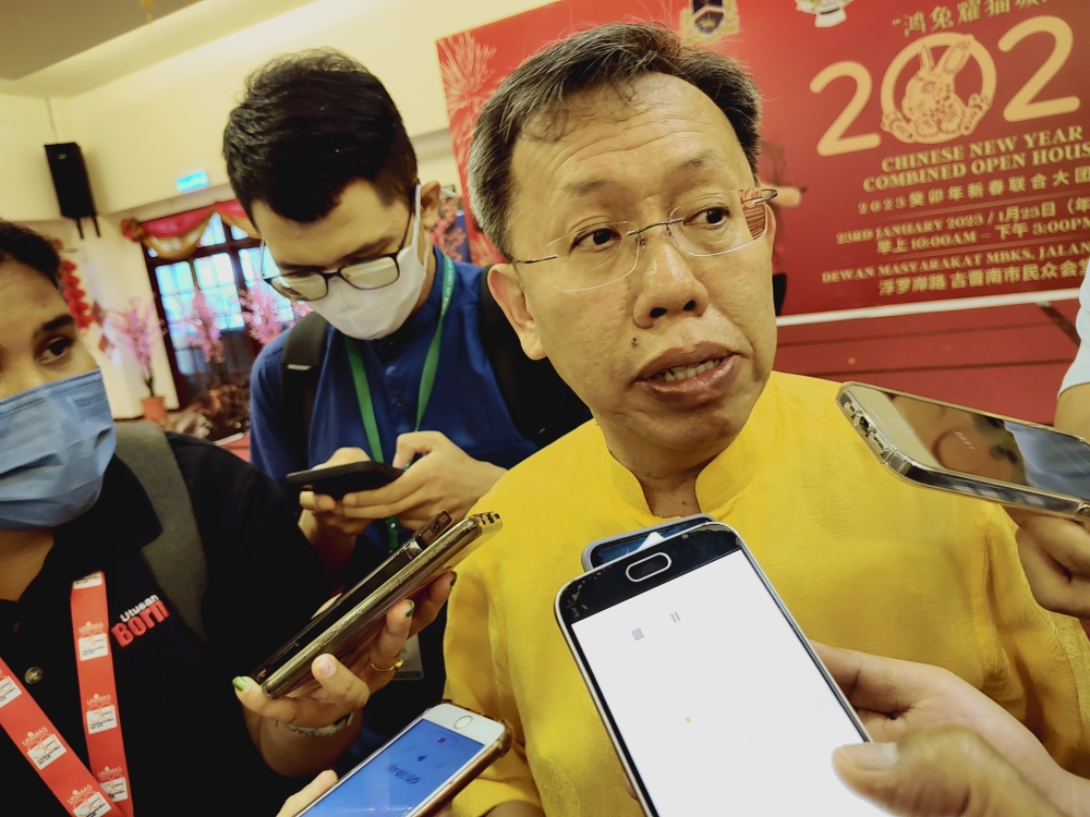 Sarawak Deputy Premier Datuk Sri Dr Sim Kui Hian speaks to reporters at his Chinese New Year Open house. Jan 23, 2022. — Picture by Sulok Tawie