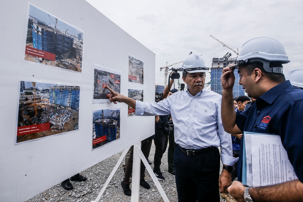 Defence Minister Datuk Seri Mohamad Hasan (centre) oversees the construction progress of the One Member One House housing programme at Sateria Residensi Platinum South Valley, Sungai Besi January 25, 2023. — Picture by Hari Anggara