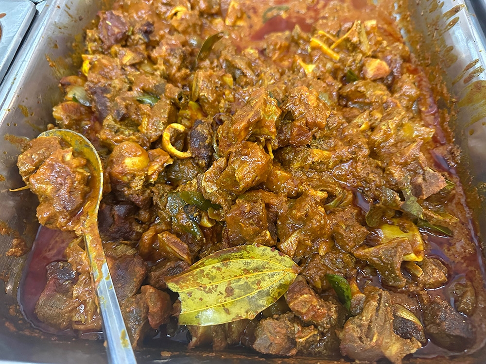 Help yourself to the mutton curry from the counter.
