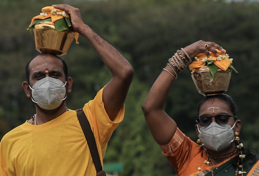 Hindu devotees carry jugs of milk (paal kodum) as offerings at the Kallumalai Arulmigu Subramaniar Temple at Gunung Cheroh in Ipoh January 27, 2023. — Picture by Farhan Najib