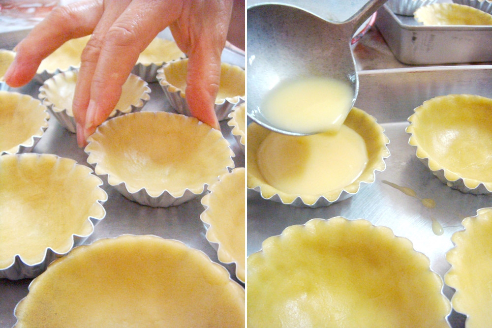 Lining the moulds with the tart dough before pouring the custard mixture.