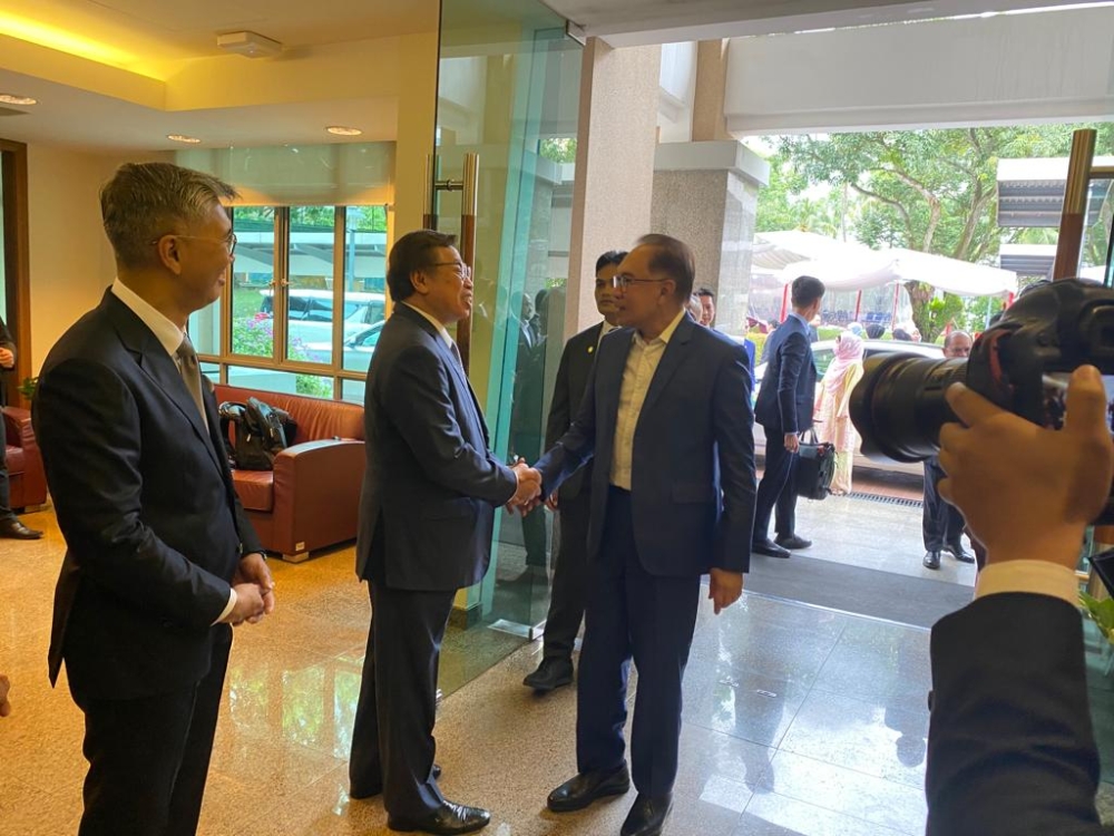 Abang Johari (second left) greets Anwar upon the latter’s arrival at the Malaysian High Commission in Singapore.  —  Picture courtesy of the Sarawak Premier’s Office/Borneo Post Online