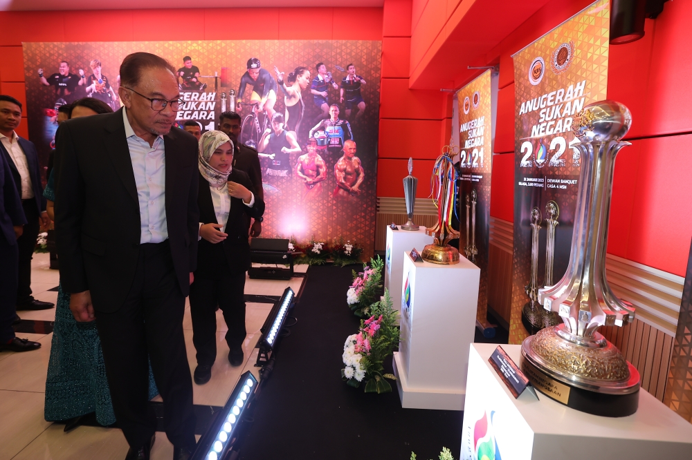 Prime Minister Datuk Seri Anwar Ibrahim looks at trophies won by Malaysian athletes during the 2021 National Sports Awards (ASN) ceremony at the National Sports Council (NSC) Banquet Hall in Bukit Jalil, Kuala Lumpur January 31, 2023. — Bernama pic