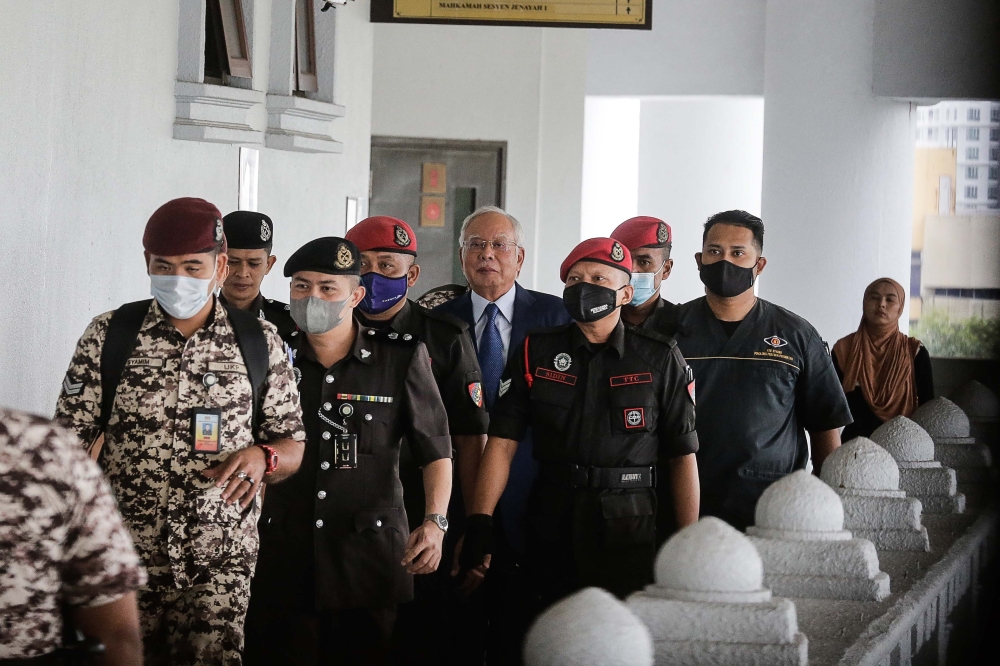 Former prime minister Datuk Seri Najib Razak is escorted by the Department of Prison personnel as he faces 1Malaysia Developement Berhad (1MDB)-related charges at Kuala Lumpur Court Complex February 2, 2023. — Picture by Sayuti Zainudin
