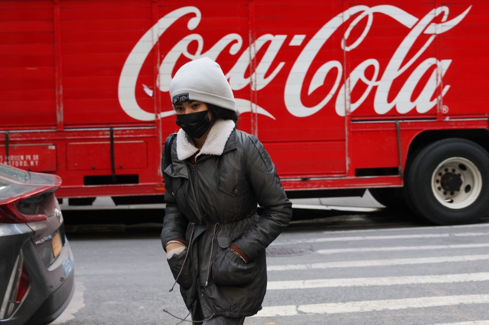 People bundle up as they shield themselves from cold winds as the area is seeing record-breaking low temperatures on February 03, 2023 in New York City. ― AFP pic