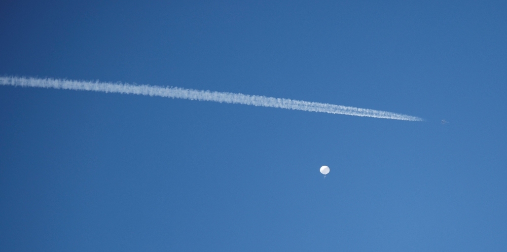 A jet flies by a suspected Chinese spy balloon as it floats off the coast in Surfside Beach, South Carolina, U.S. February 4, 2023. — Reuters pic
