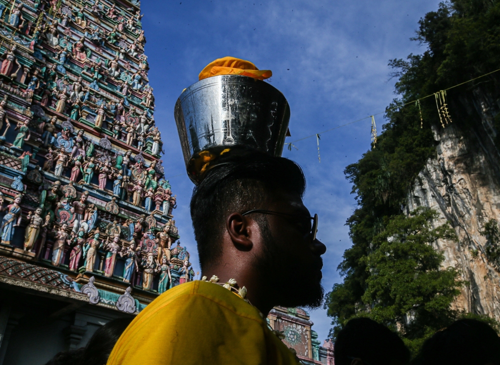 A devotee carrying a milk pot at the Kallumalai Arulmigu Subramaniar Temple in Gunung Cheroh, Ipoh. — Picture by Farhan Najib