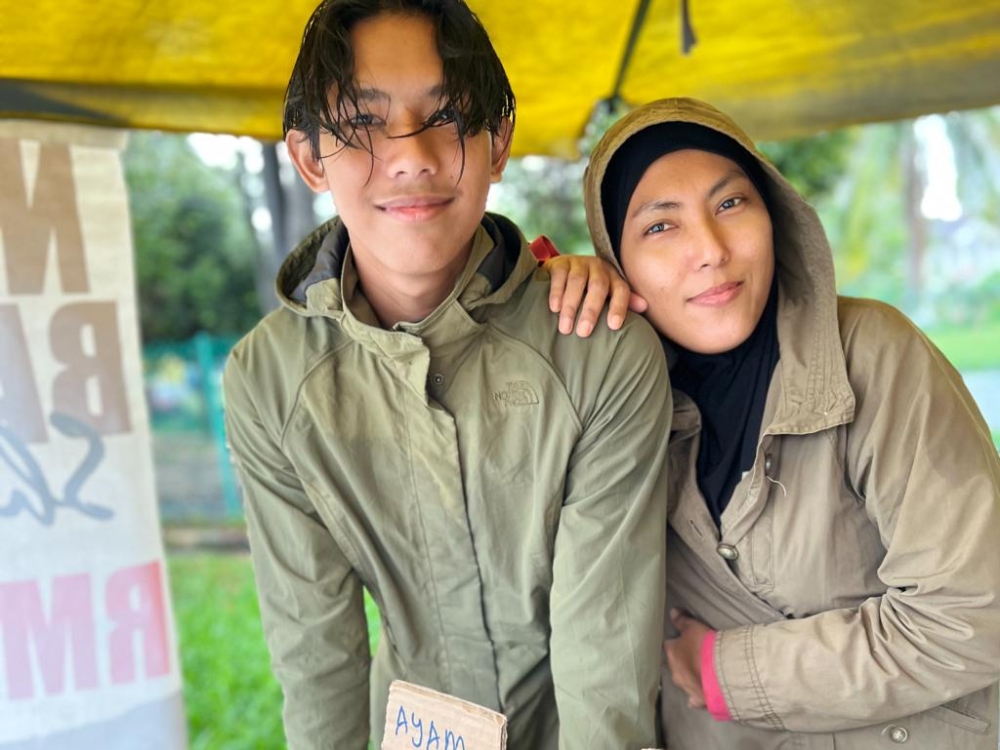 Arfan helping out Shima while on semester break last year. — Picture courtesy of Nurul Shima