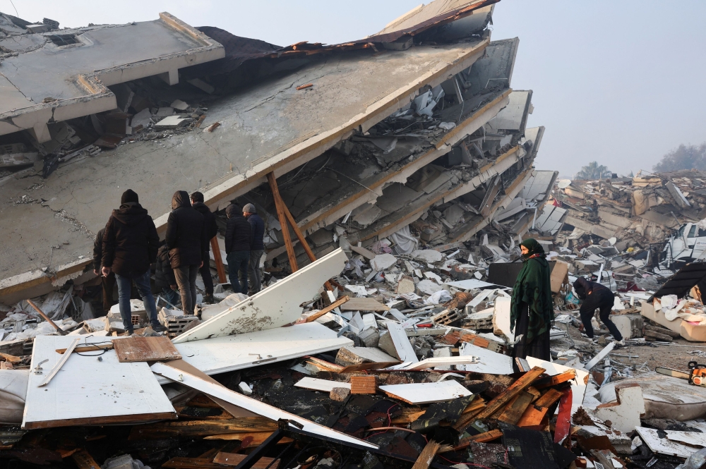 People look at rubble and damage following an earthquake in Hatay, Turkey February 7, 2023. ― Reuters pic
