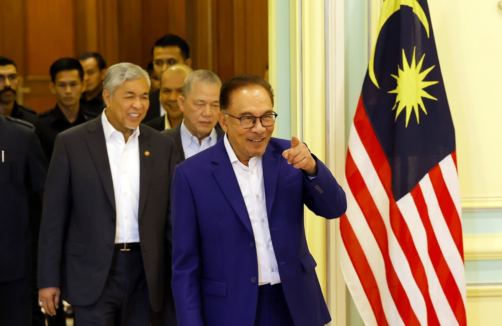 Prime Minister Datuk Seri Anwar Ibrahim (right) arrives for a press conference after chairing the Cabinet meeting in Putrajaya February 8, 2023. — Bernama pic