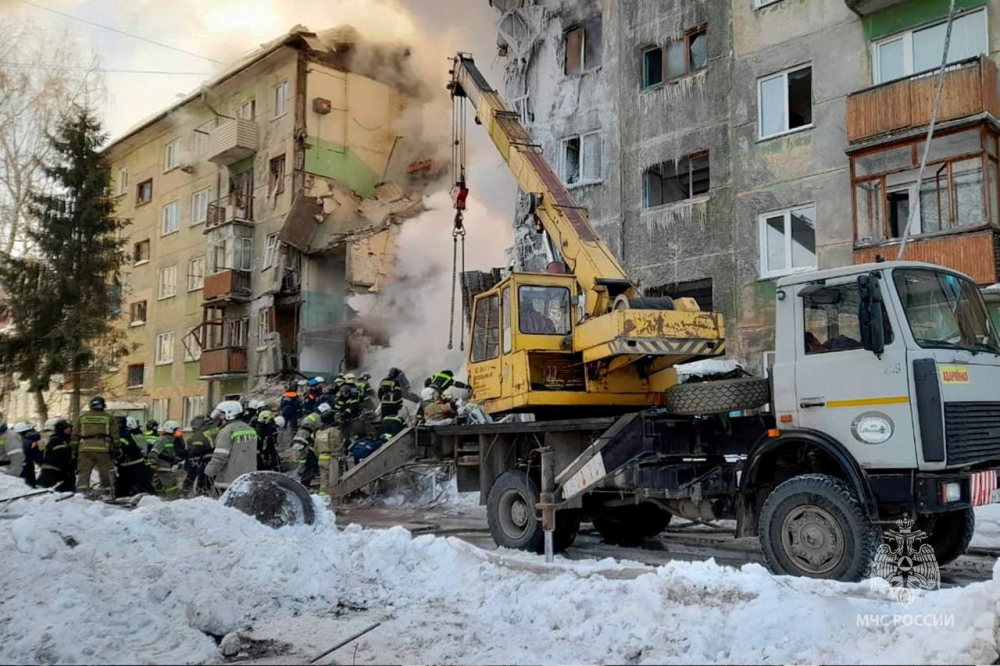 Rescuers remove the rubble of a five-floor residential building heavily damaged in a gas explosion in Novosibirsk, Russia February 9, 2023. — Russian Emergencies Ministry handout via Reuters