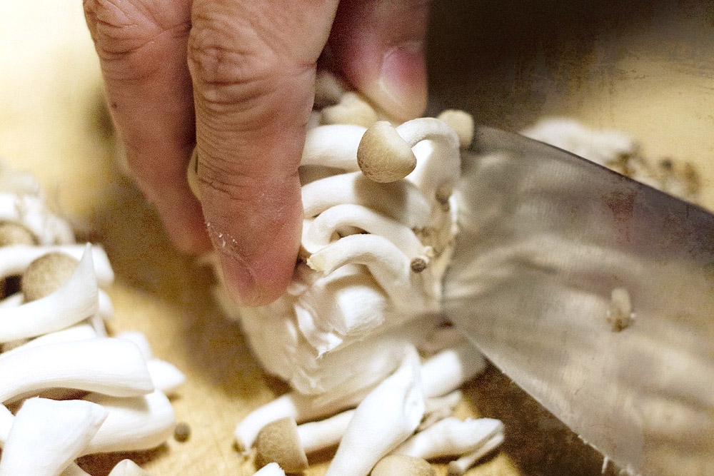 Slicing some 'bunapi' mushrooms.