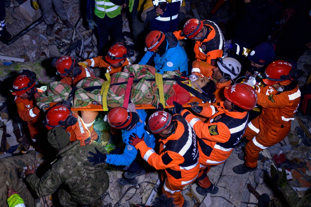 Rescuers stretcher away Ece Koseoglu, 25-year-old, after being removed from under the rubble of a collapsed building following two massive back-to-back earthquakes that affected both Turkey and Syria earlier in the week, in Antakiya, Hatay province, southern Turkey on February 10, 2023. ― AFP pic