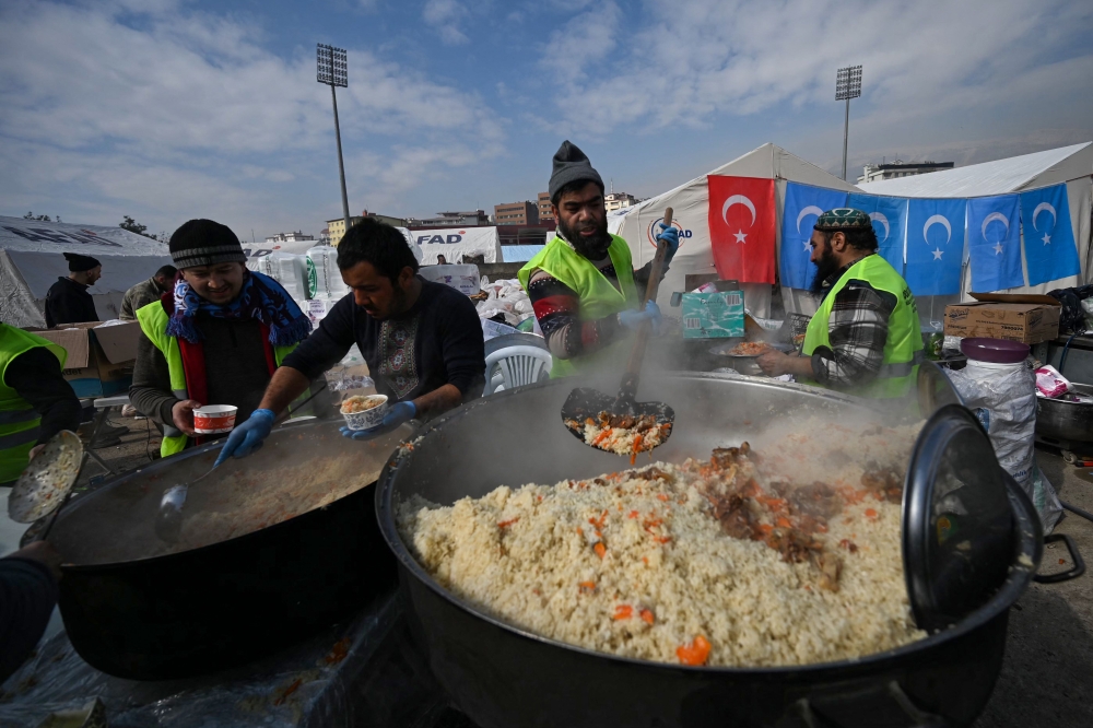 Volunteers prepare some food for quake-hit residents at a stadium in Kahramanmaras on February 10, 2023, after a 7.8-magnitude earthquake struck the country’s southeast earlier in the week. ― AFP pic