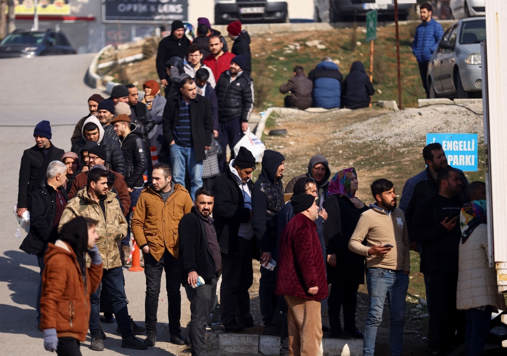 People queue in line to receive medication in the aftermath of a deadly earthquake in Kahramanmaras, Turkey February 11, 2023. ― Reuters pic