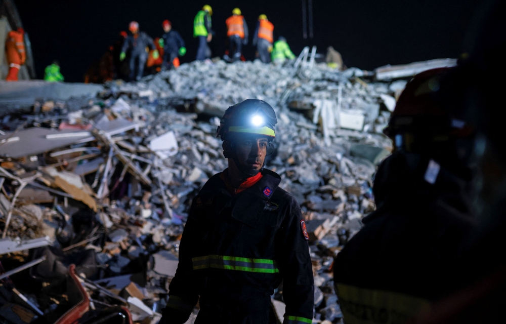 Members of a Greek rescue team work on the site of a collapsed building, as the search for survivors continues, in the aftermath of a deadly earthquake, in Hatay, Turkey February 11, 2023. — Reuters pic