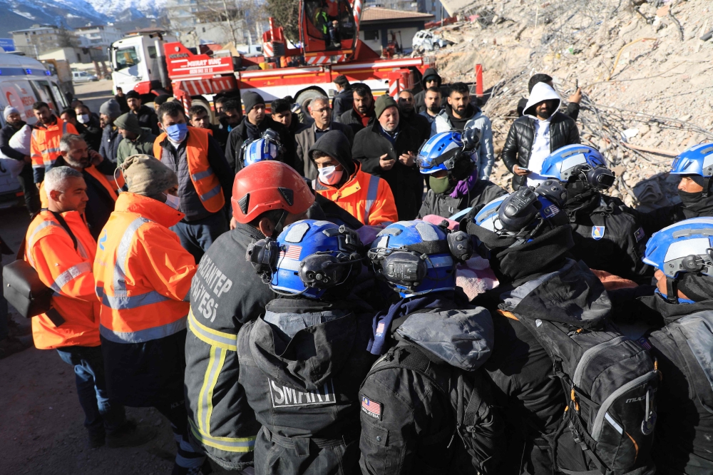 Malaysian and Turkish rescuers carry a person retrieved from the rubble of collapsed buildings in Nurdagi, in the countryside of Gaziantep, on February 9, 2023, three days after a deadly earthquake that hit Turkey and Syria. — AFP pic
