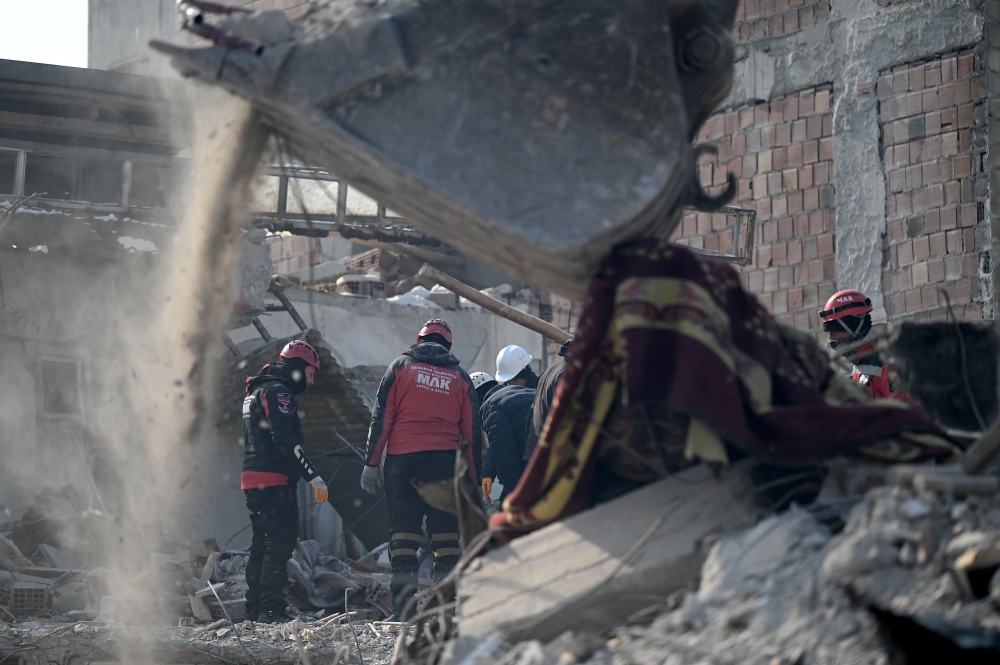 Rescue teams carry out search operations among the rubble of collapsed buildings  at Elbistan district of Kahramanmaras on February 11, 2023, after a 7.8-magnitude earthquake struck the country's south-east earlier in the week. — Reuters pic