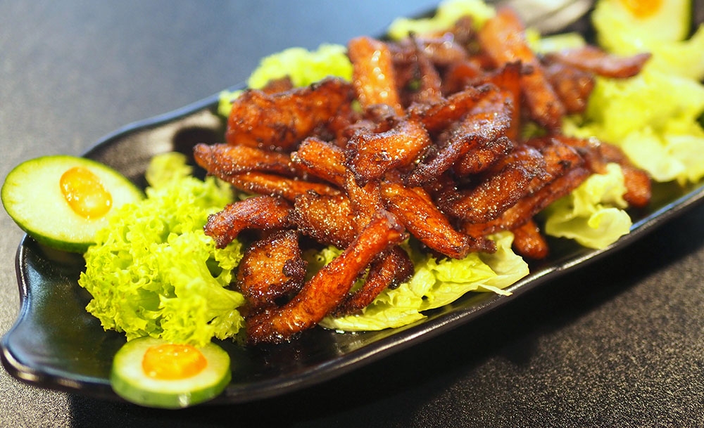 Relish caramelised Pork Jowl with Vegetables tossed in a tangy juice .