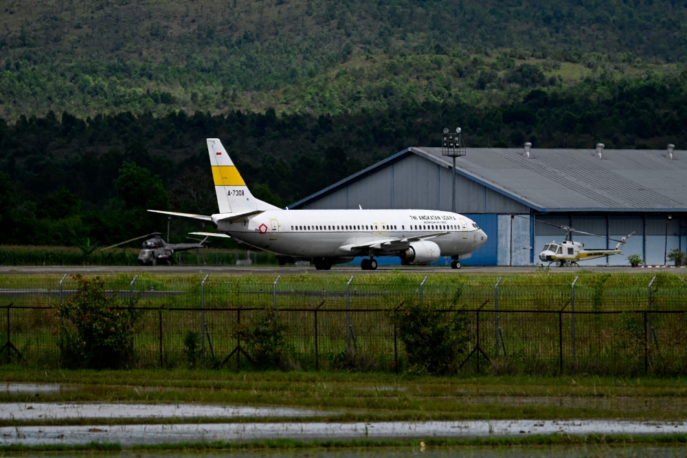 An Indonesian Air Force aircraft carrying military personnel and search and rescue team members, assigned to help those affected by the 7.8 magnitude earthquake that hit Turkey and Syria, is seen after it landed for refueling at the Sultan Iskandar Muda Air Force Base in Blang Bintang in Aceh province on February 11, 2023. — AFP pic