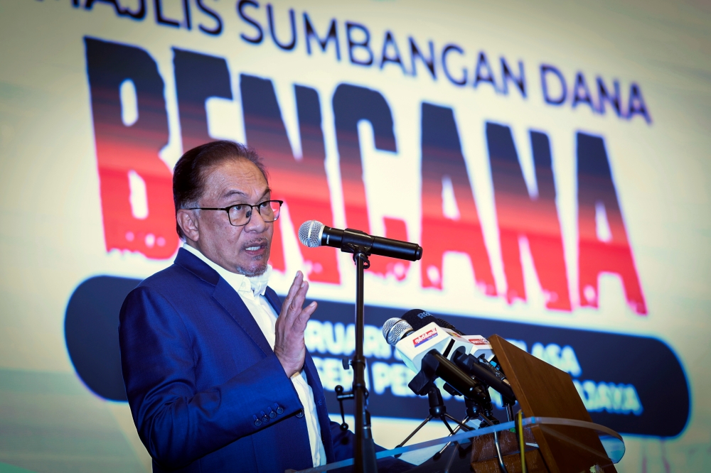 Prime Minister Datuk Seri Anwar delivers a speech at a disaster fund donation ceremony by private companies to the Disaster Fund of the Ministry of Foreign Affairs in Putrajaya February 14, 2023. — Bernama pic