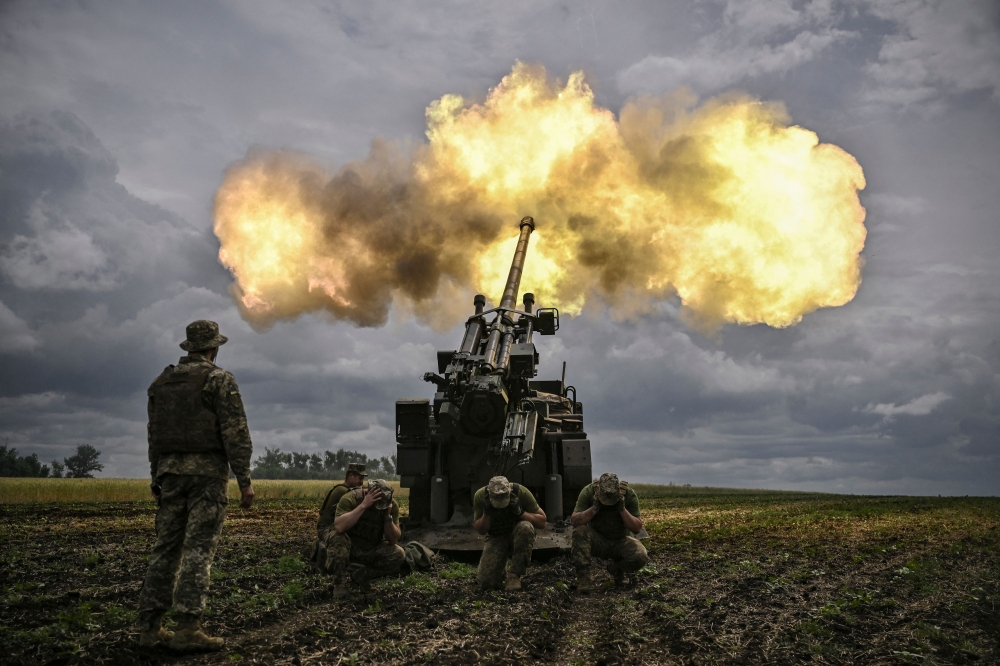 Ukrainian servicemen fire with a French self-propelled 155 mm/52-calibre gun Caesar towards Russian positions at a front line in the eastern Ukrainian region of Donbas, June 15, 2022. — AFP pic