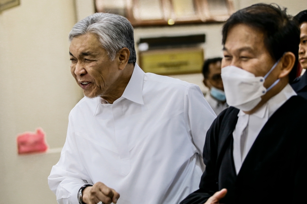 File picture shows Deputy Prime Minister Datuk Seri Ahmad Zahid Hamidi together with his lawyer Datuk Hisyam Teh Poh Teik (right) leaving the courtroom at Kuala Lumpur High Court, February 3, 2023. — Picture by Hari Anggara