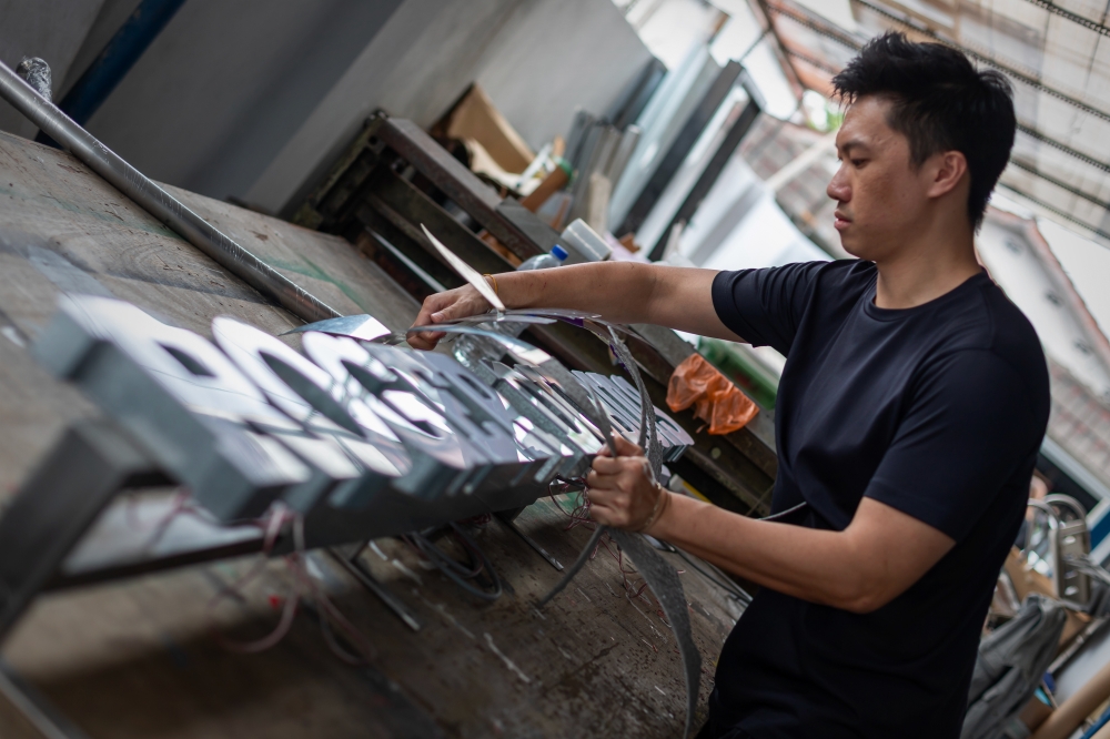 Light artist Jun Ong working on his luminescent installation for the Roger Dubuis boutique. — Picture courtesy of Roger Dubuis