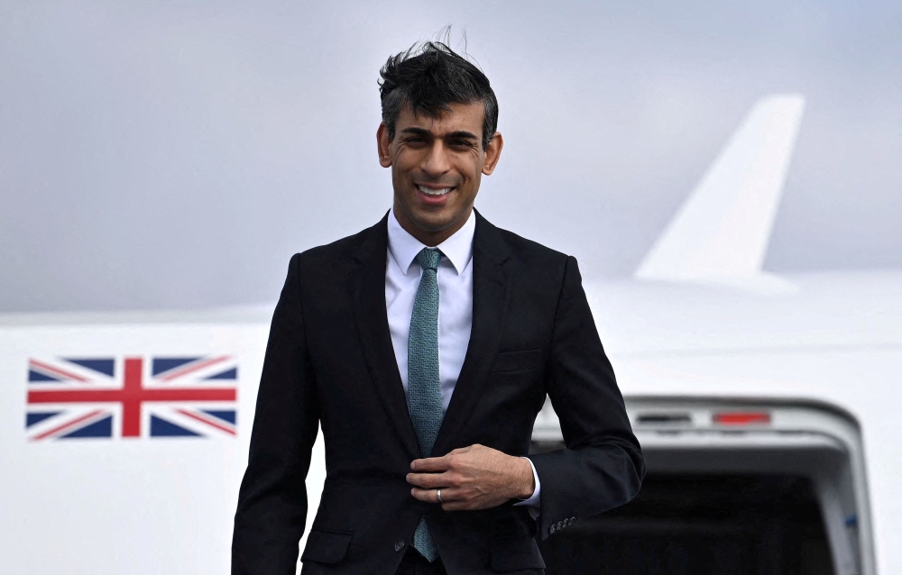 British Prime Minister Rishi Sunak gets off his plane after his arrival on February 18, 2023 at the airport in Munich, southern Germany, where he will attend the Munich Security Conference (MSC). — Reuters pic