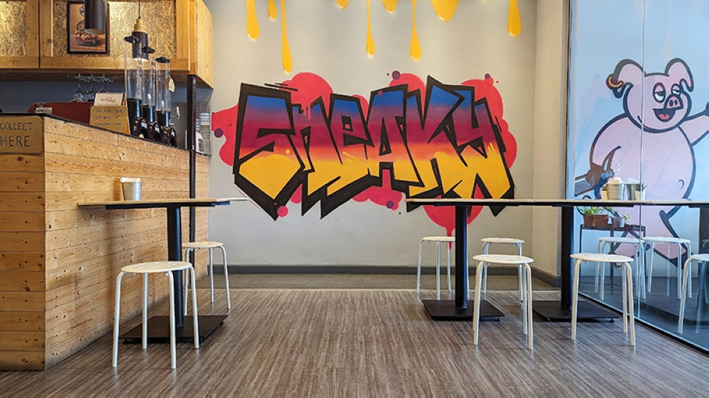 The decor at Sneaky Burgers is bold and lively, just like their burgers.