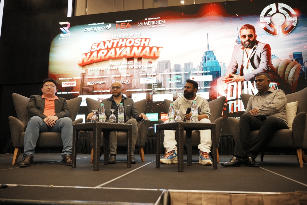 Santhosh (in white) during his recent press conference in Kuala Lumpur to promote his upcoming concert. (From left) Co-founder of Ticket2u Wooi Chang Tan and show organising partners B.Yugeswaran and S.Suresh. — Picture courtesy of Reacch Production