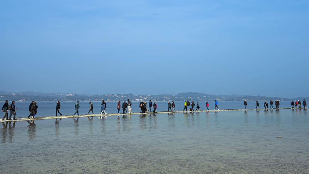 People walk towards the small island of San Biagio. — AFP pic