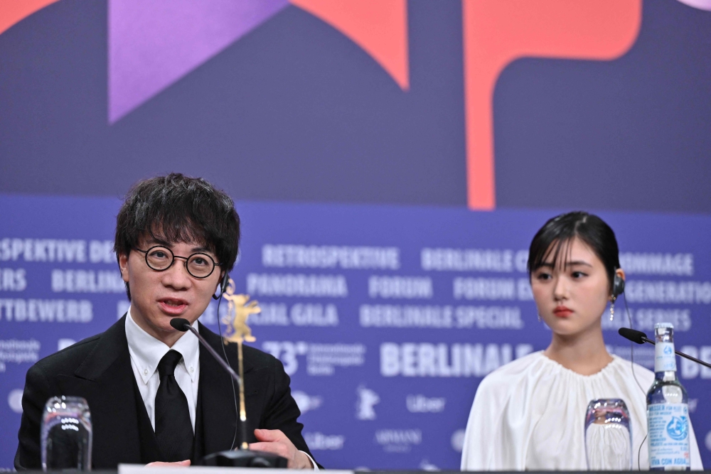 Japanese director and screenwriter Makoto Shinkai and Japanese actress Nanoka Hara attend a press conference for the film 