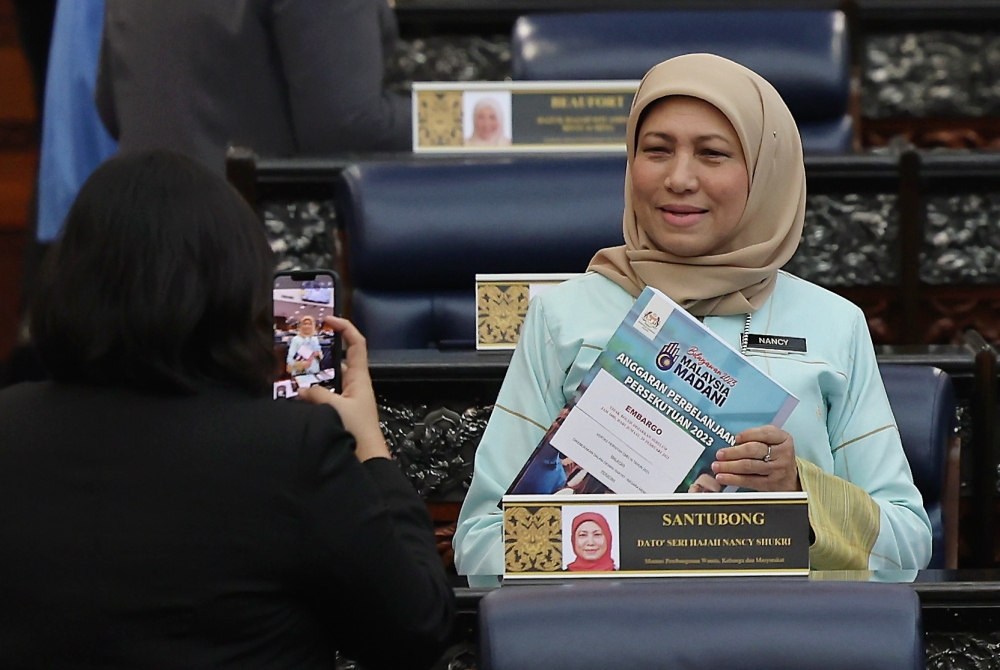 Minister of Women, Family and Community Development Datuk Seri Nancy Shukri posing with the budget book presented by the Prime Minister who is also Finance Minister for the Malaysia MADANI Budget 2023 in Parliament, Kuala Lumpur, February 24, 2023. — Bernama pic