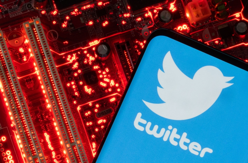 A smartphone with a displayed Twitter logo is placed on a computer motherboard in this illustration taken February 23, 2023. — Reuters pic