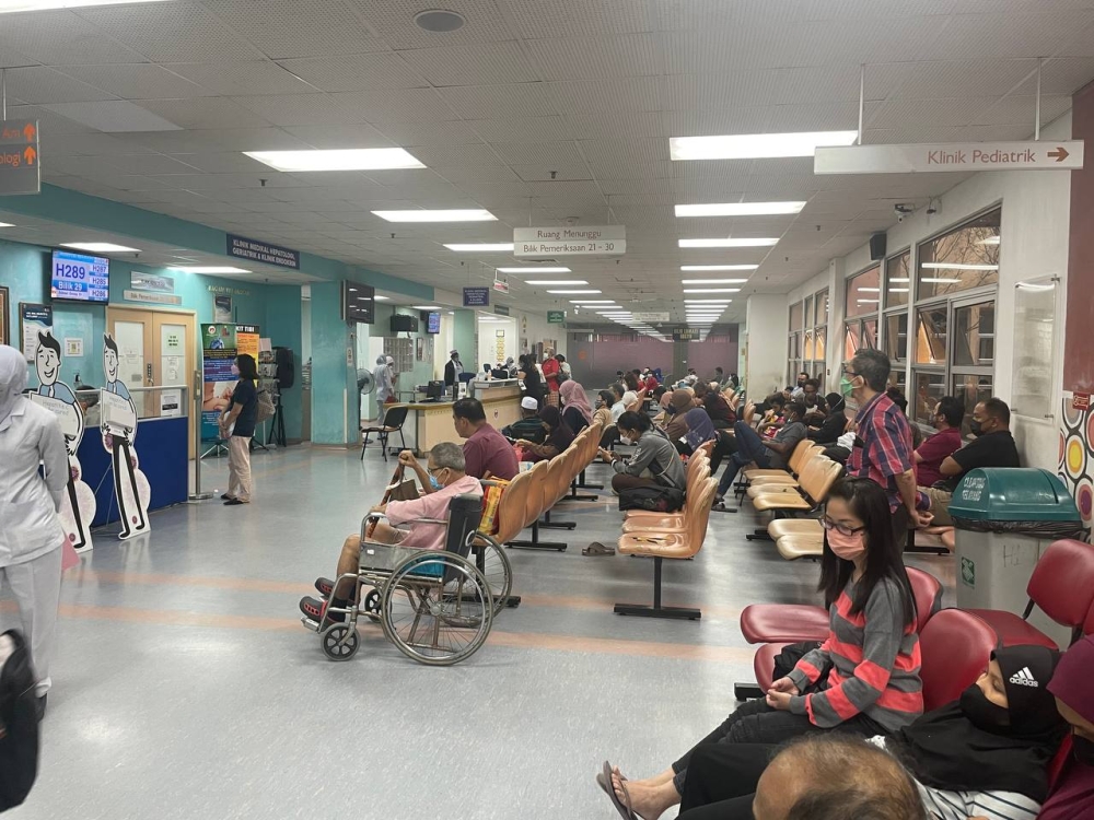 Selayang Hospital's specialist clinic waiting area appears crowded in the late afternoon hours of February 16, 2023, with several patients saying they have been waiting for treatment for over five hours. — Picture by Rex Tan