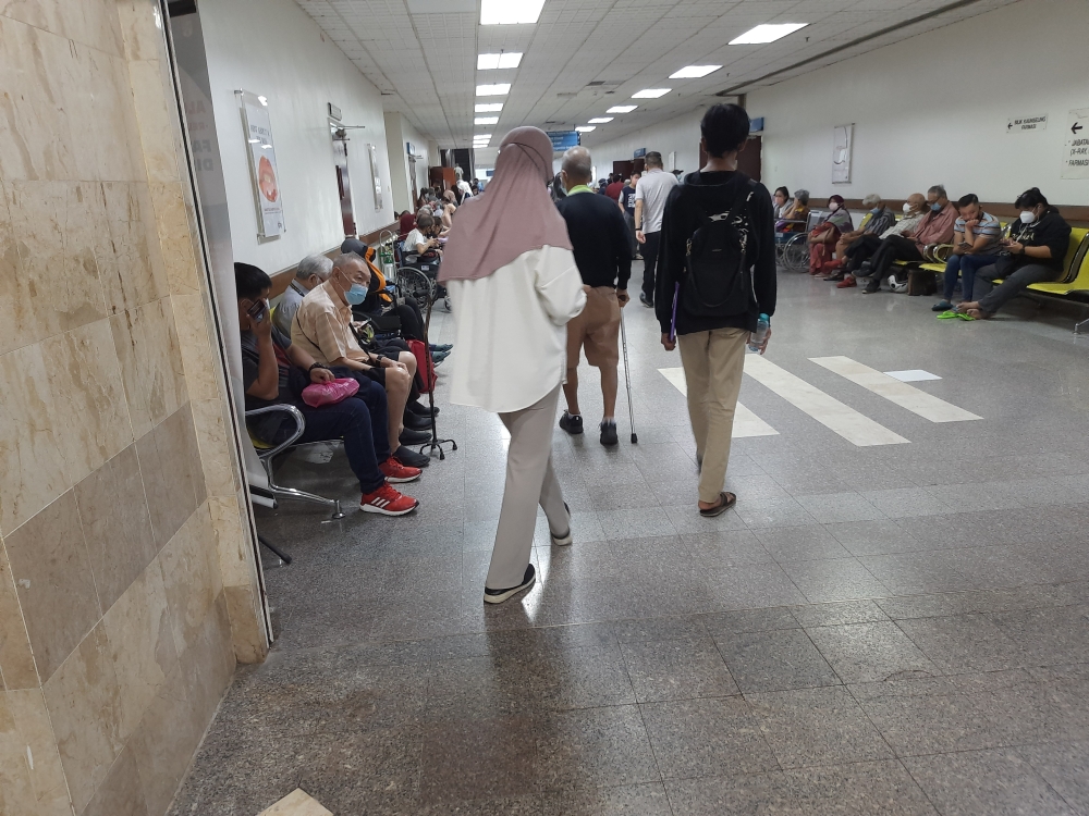 The waiting area near the outpatient specialist clinic of Hospital Canselor Tanku Muhriz UKM (HCTM), seen packed with waiting patients at 8.45am on February 20, 2023. — Picture by Keertan Ayamany