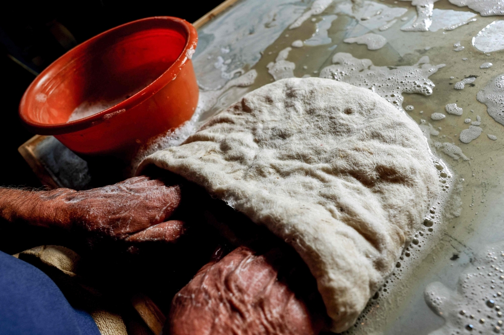 Hatmaker Youssef Akiki shapes one of his traditional 